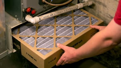 Worker installing HVAC filter